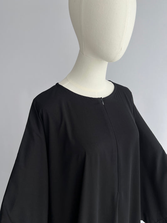 Essential Zip Abaya upper body detail, front view showing neckline and chest area