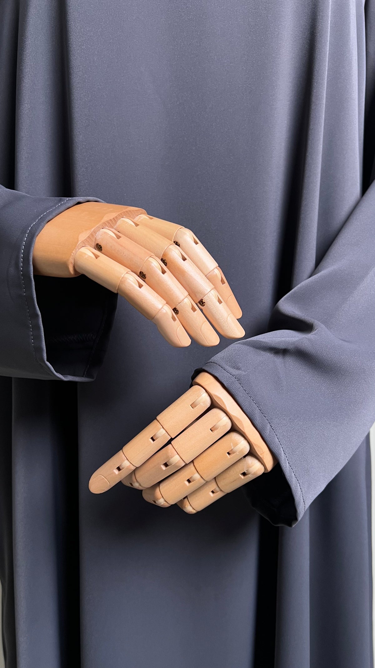 Close-up of the sleeve openings on the dark grey Safiyyah Closed Abaya