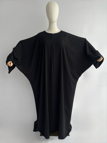 Essential Zip Abaya width demonstration, front view showing fabric span