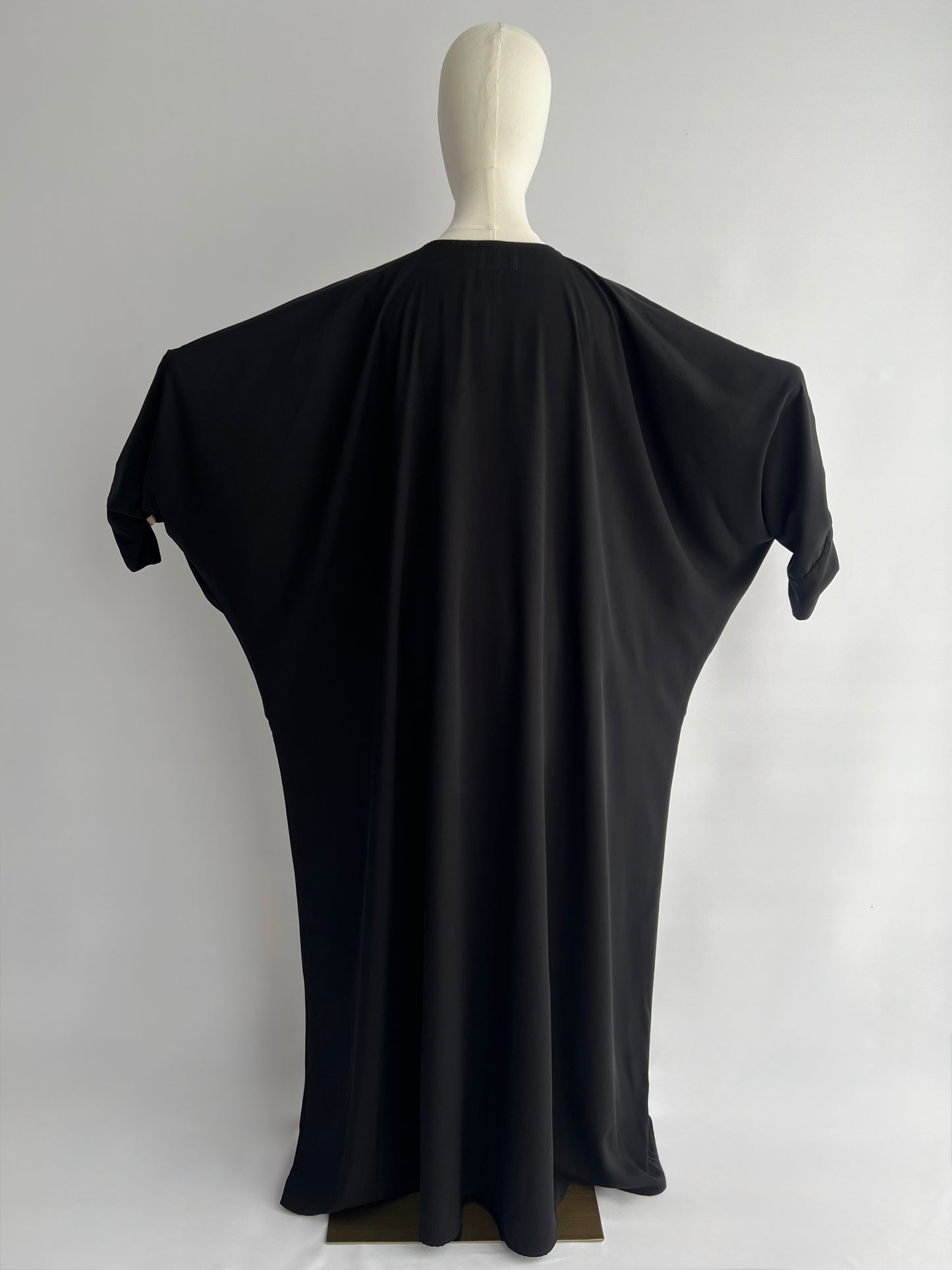 Essential Zip Abaya width demonstration, back view showing fabric span