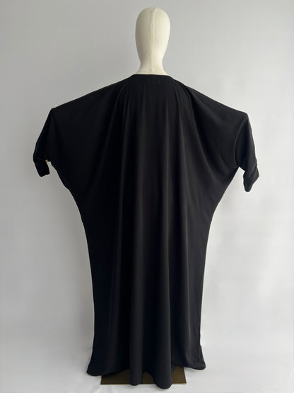 Essential Zip Abaya width demonstration, back view showing fabric span