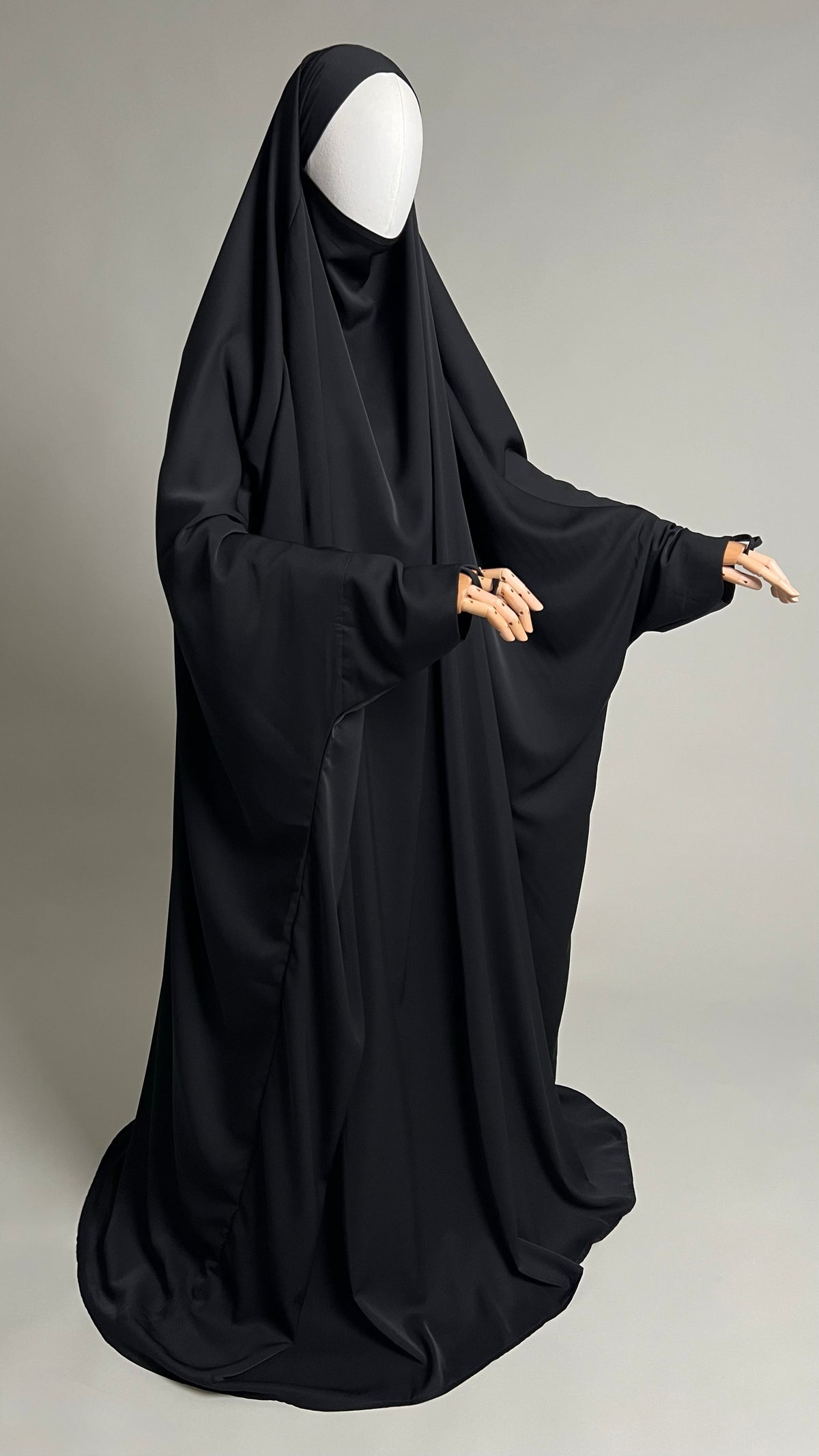 Black Zaynab One-Piece Jilbab, full-length front view with one arm extended